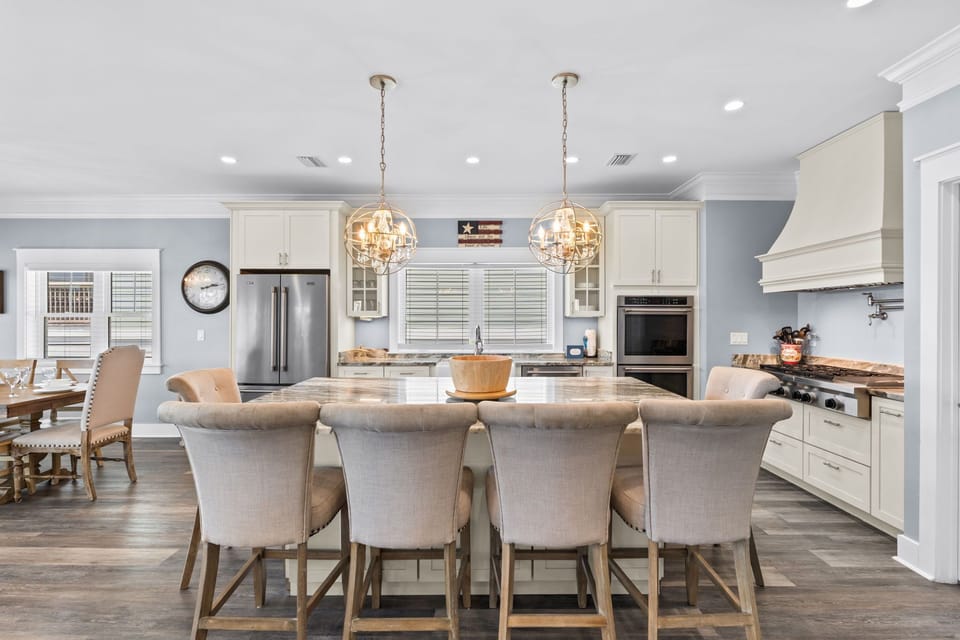 Your gourmet kitchen invites culinary adventures with gleaming countertops, premium appliances, and elegant pendant lighting creating the perfect gathering space.
