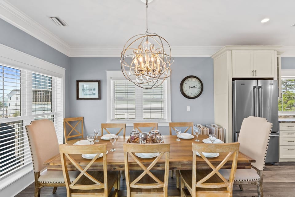 Gather around your elegant dining table for memorable meals beneath the stunning chandelier in this beautifully appointed space.