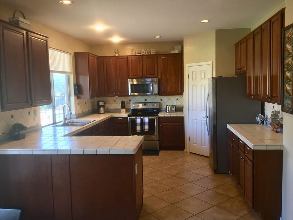 Fully stocked kitchen, large walk in pantry, dishwasher, views of lovely yard