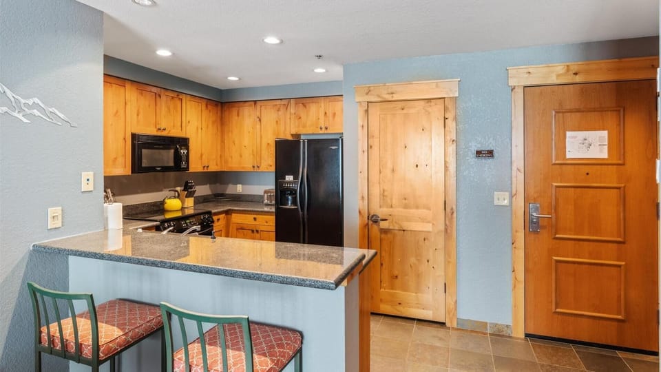Fully stocked kitchen with breakfast bar seating for 2