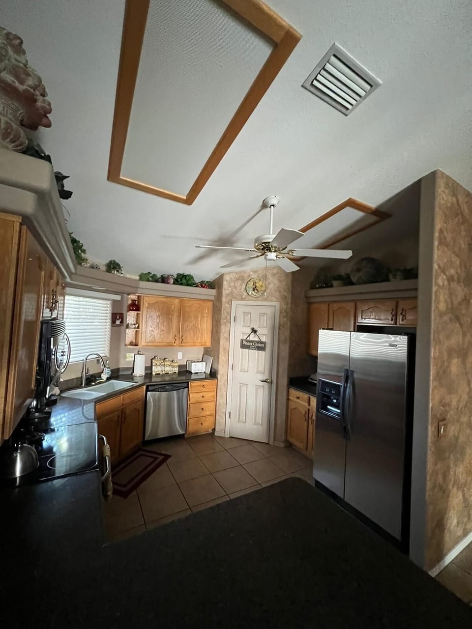 Kitchen with oven, large refrigerator, microwave, coffee maker , and blender