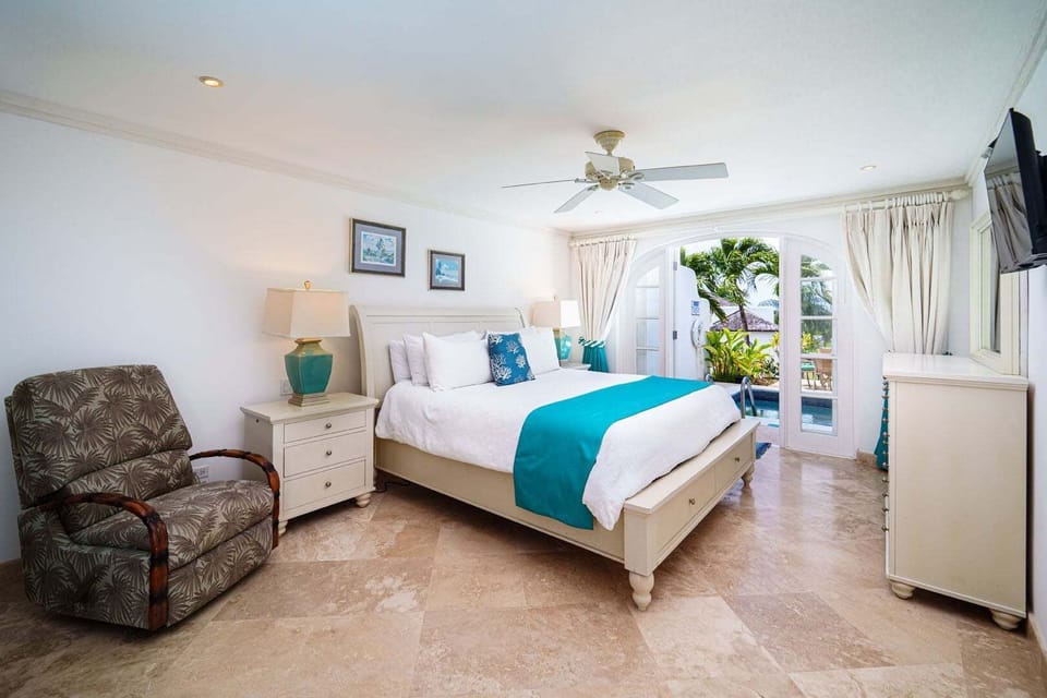 The second bedroom with a king bed, television and direct access to the pool deck