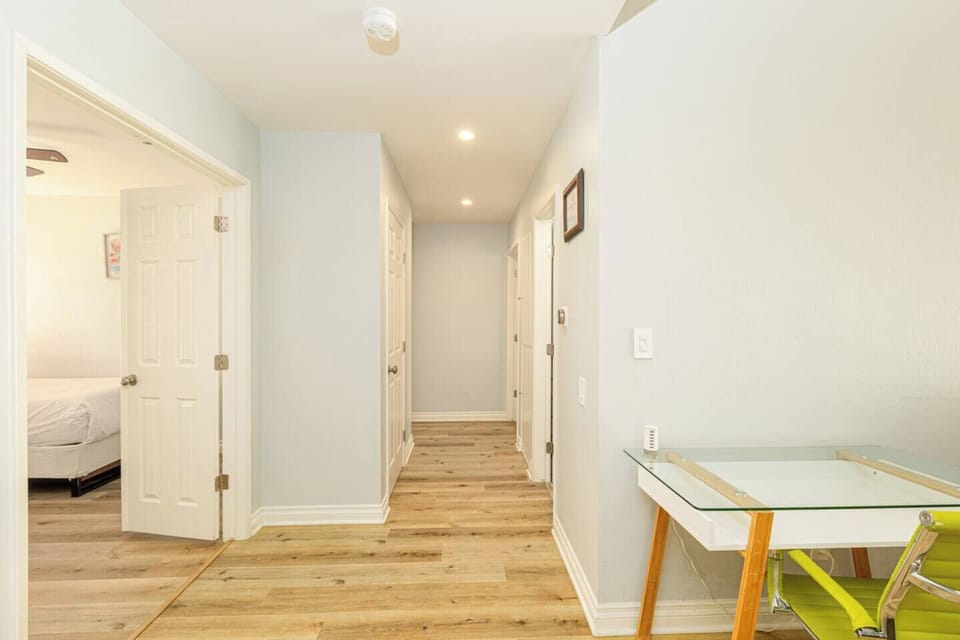 There are computer desks in the living and bedroom areas