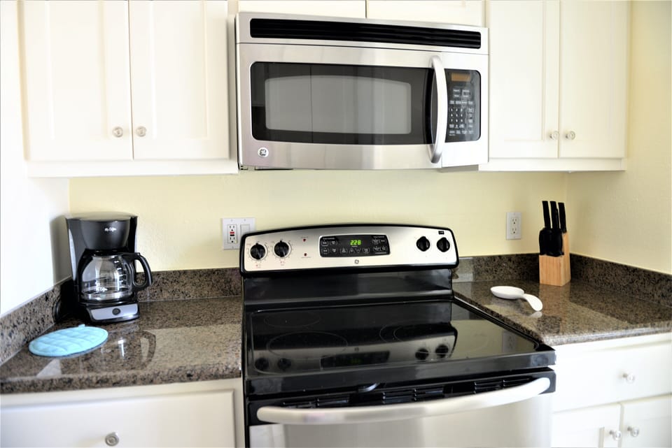 Full kitchen with utensils, pans, and dishes for a convenient stay.