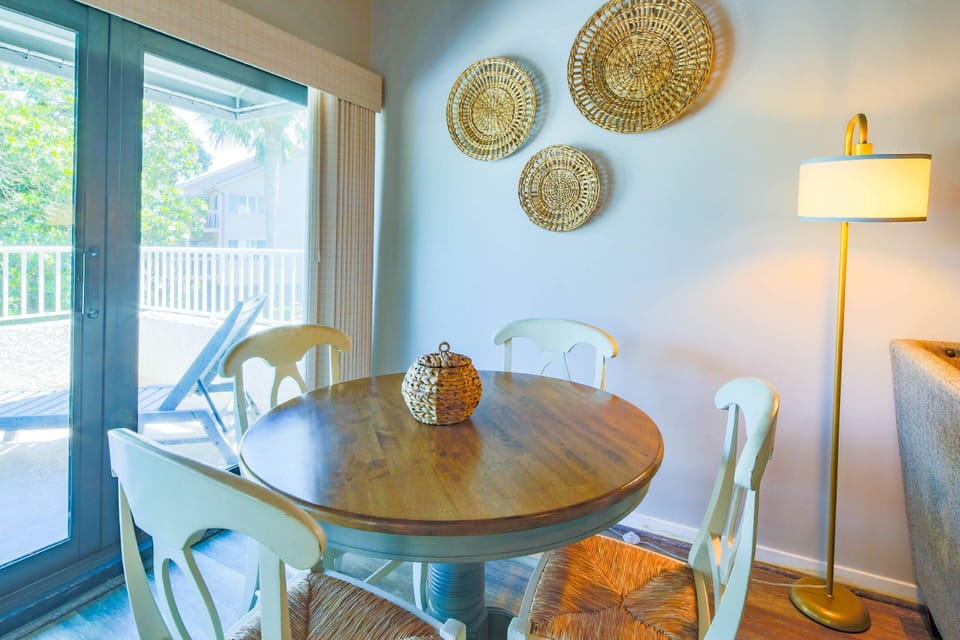 This table, which seats 4, is located in between the living room sectional and the back porch.