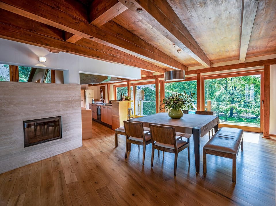 Dining area with a gorgeous garden view and fireplace.
