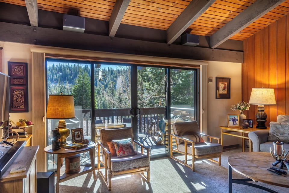 Living room has TV and private deck.