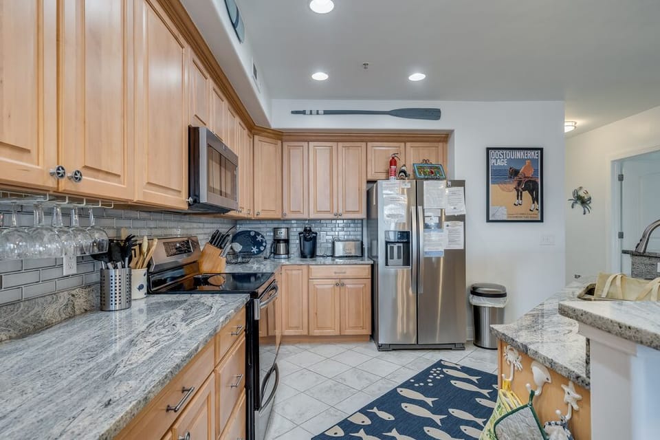 Warm Wood Cabinetry & Custom Tile Back Splash add to Sunset Bay 209`s beauty.