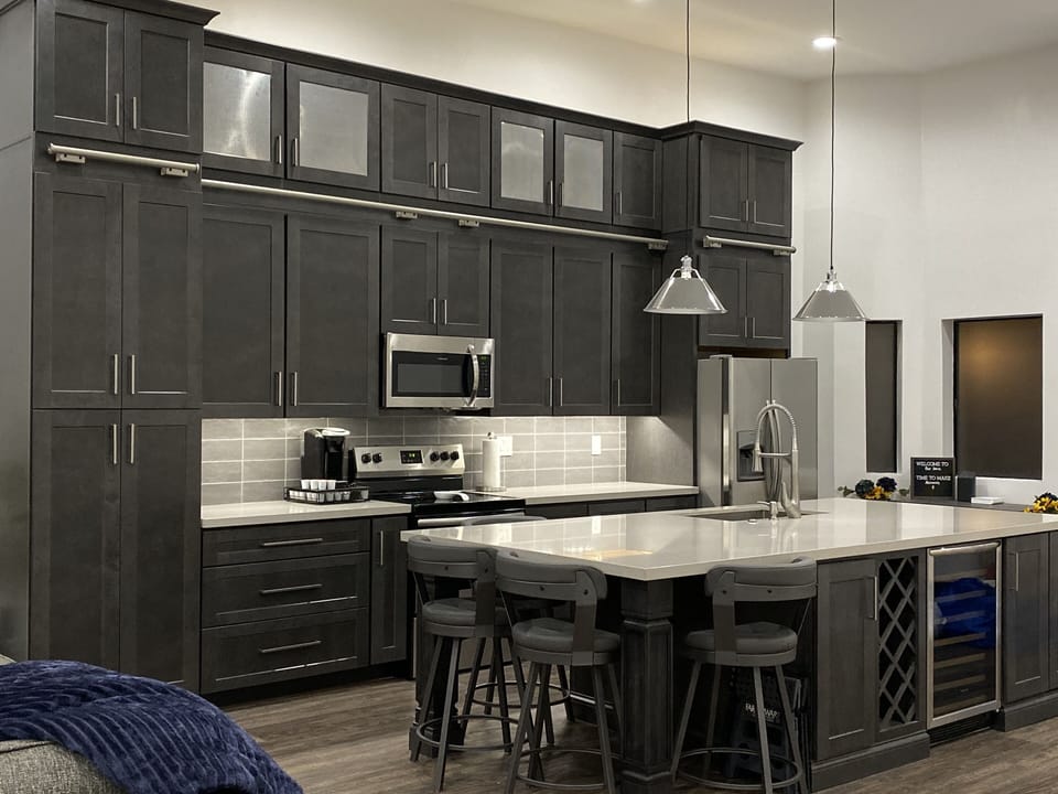 The massive island features a wine fridge and rack. 