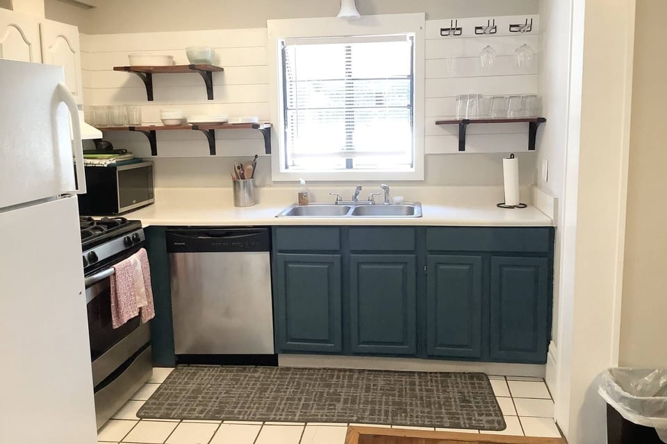 The kitchen is stocked full of your dinning and cooking needs, you enter into the kitchen from the door that is to the left of this photo