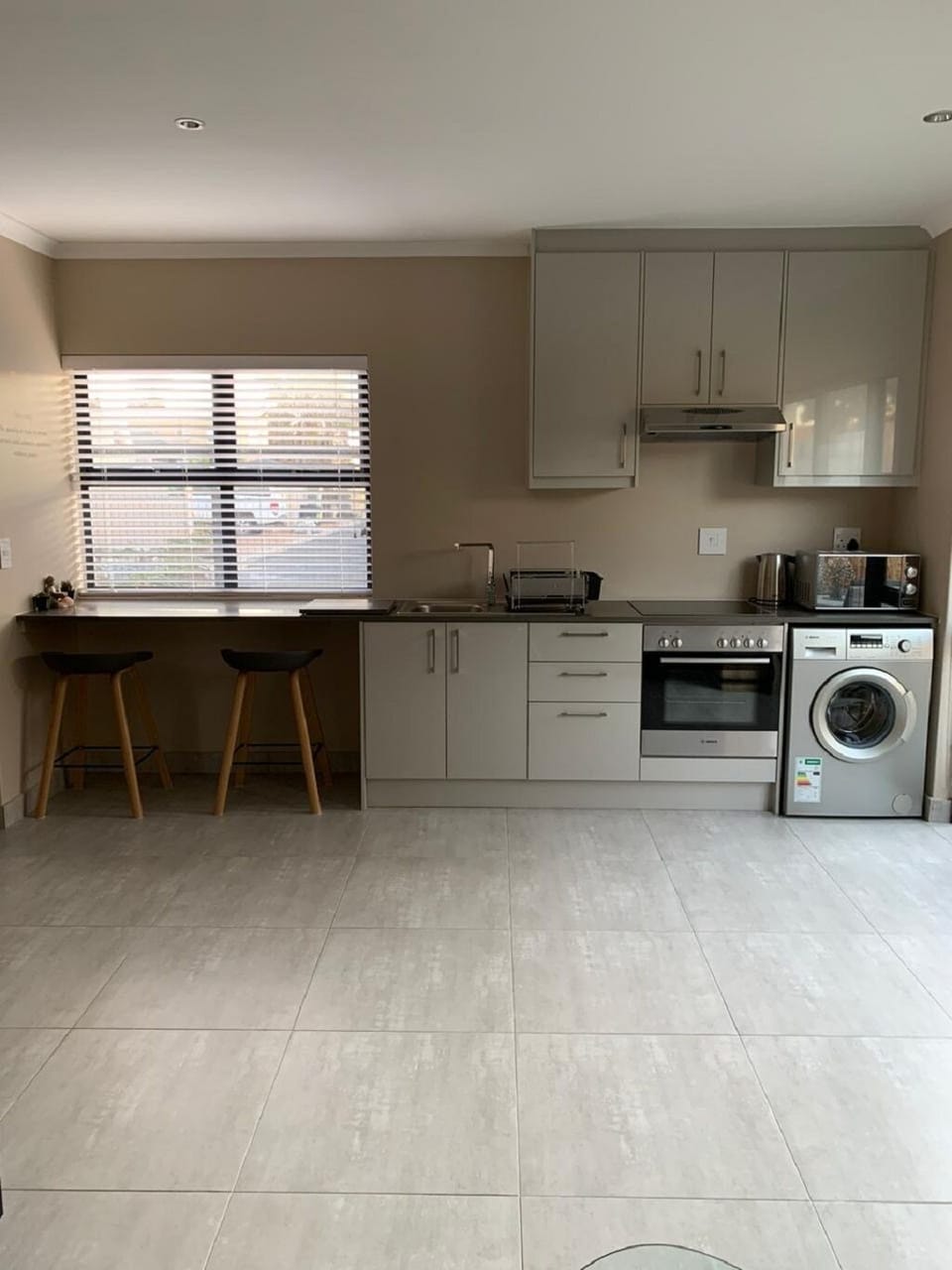 Kitchen with washing machine and oven and breakfast nook 