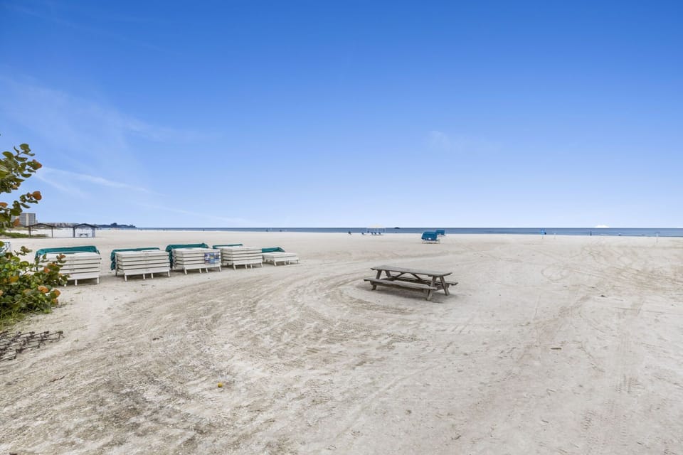 Sandy beach with picnic table and wide ocean views