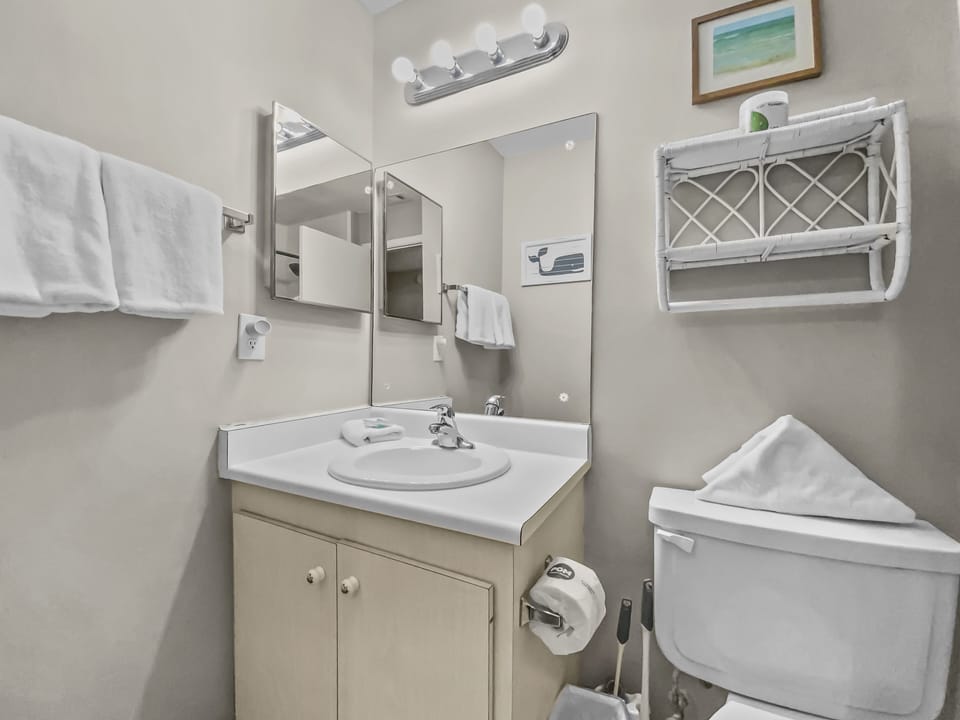 Bathroom with vanity, mirror, and toilet