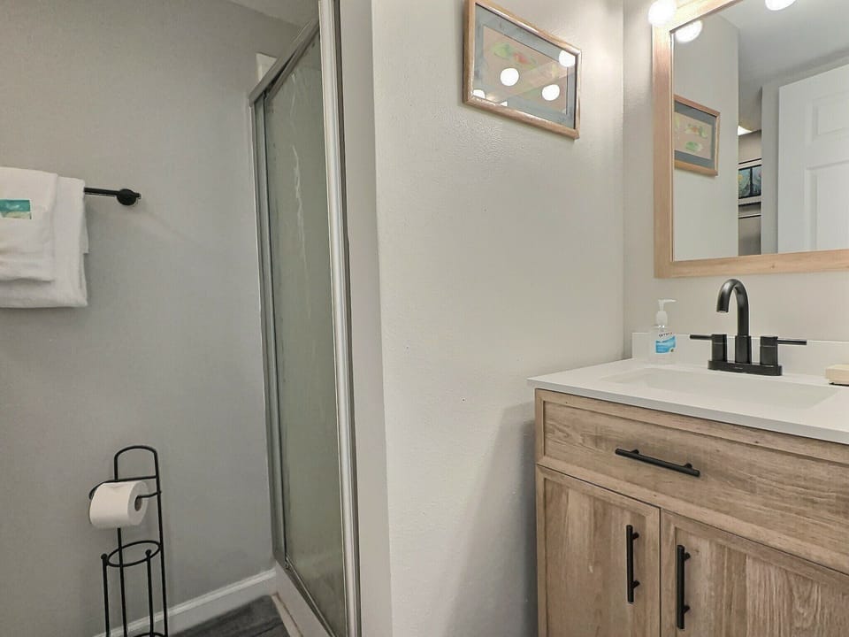 Bathroom vanity with light wood cabinets and sink