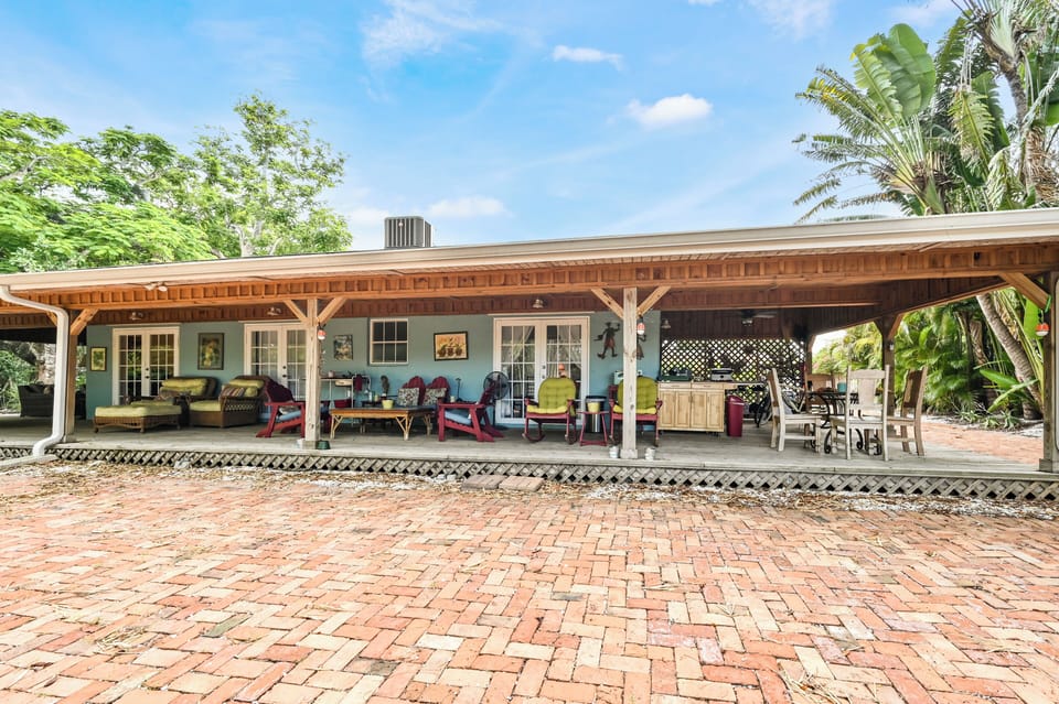 Veranda with french doors to Sweet Bungalow, kitchenette, dining and lounging.