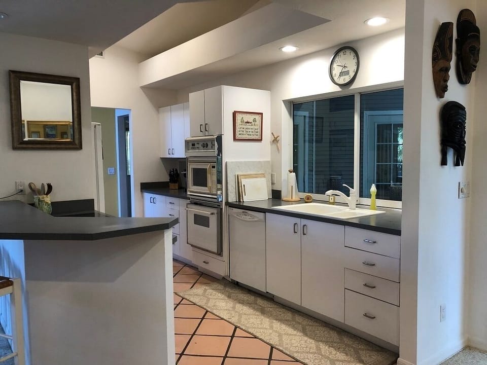 Galley kitchen opens to back patio