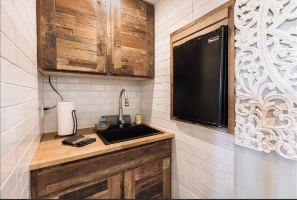 Kitchenette includes microwave, tiny fridge and dishes. 