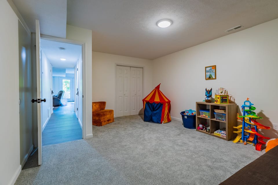 Lower level play room is stocked with toys and games for kiddos