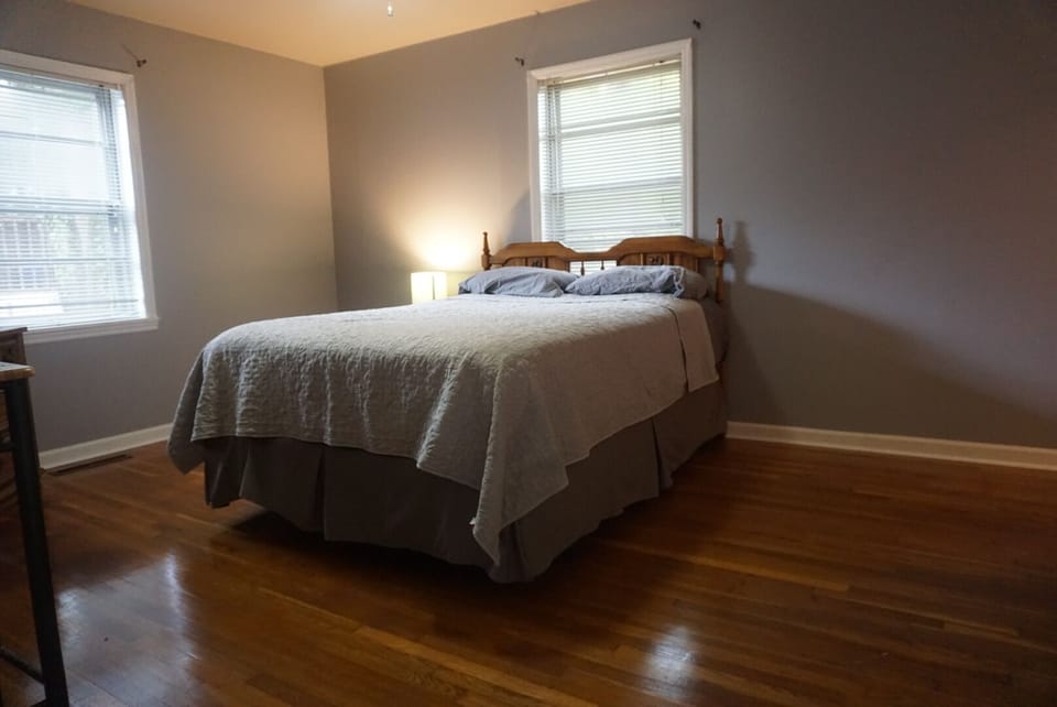 Large Master Bedroom with queen bed and hardwood floors throughout