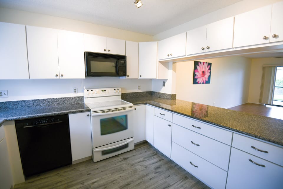 Spacious updated kitchen with granite countertops.
