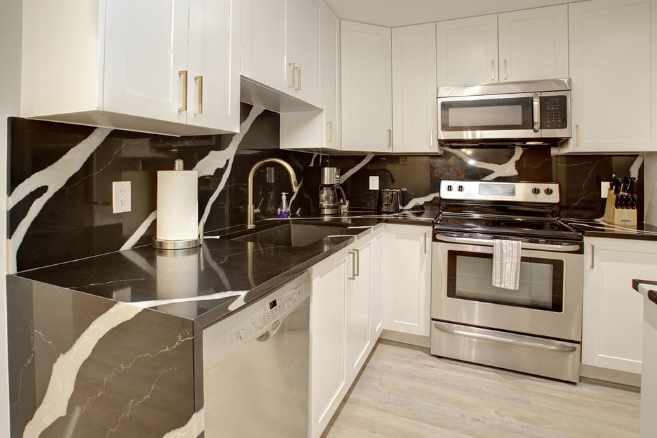 Open concept an fully equipped and remodelled kitchen with stainless appliances 