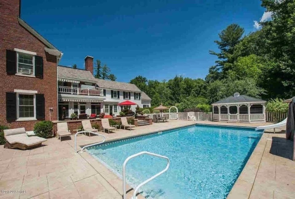 Pool with slide, water toys, lounge chairs, gazebos. Open May - September
