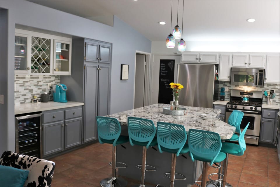 Kitchen with bar, separate drink fridge, coffee service.