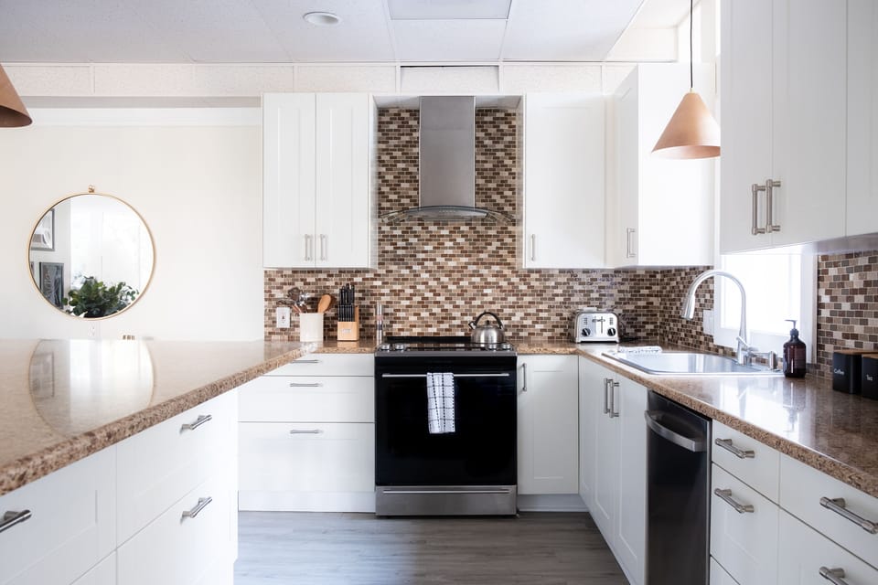 The kitchen features state of the art appliances.