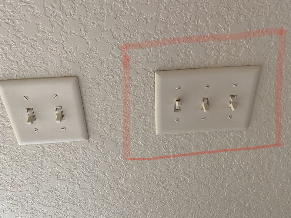 Switch next to sliding door. DO NOT touch switch in red, controls the curtain 