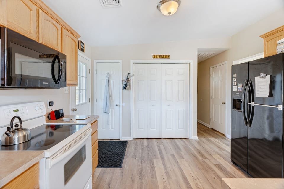 Kitchen area, door leads to patio and outside. Washer and Dryer behind doors. 
