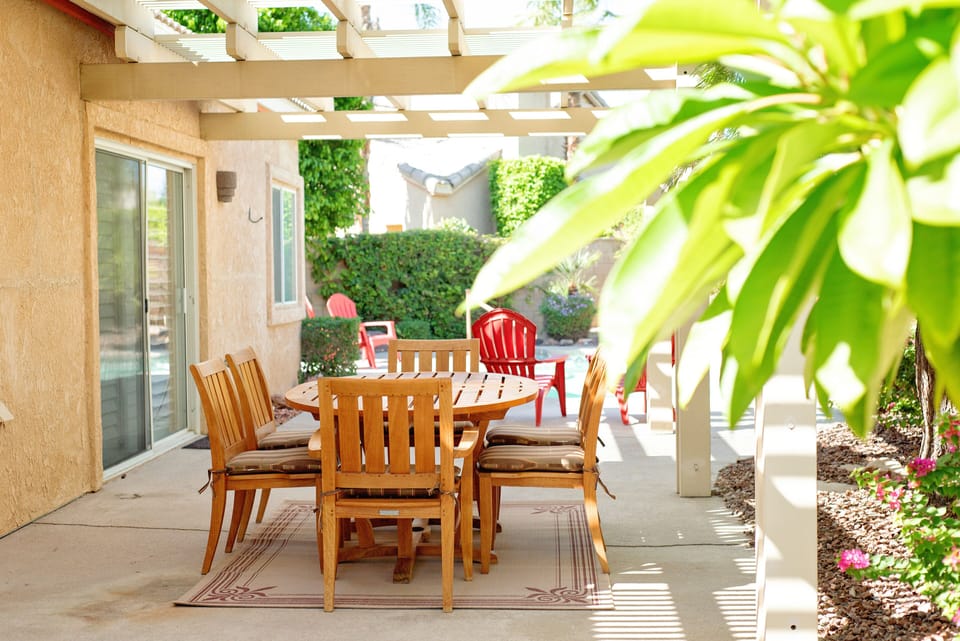 covered patio area for dining in the private backyard