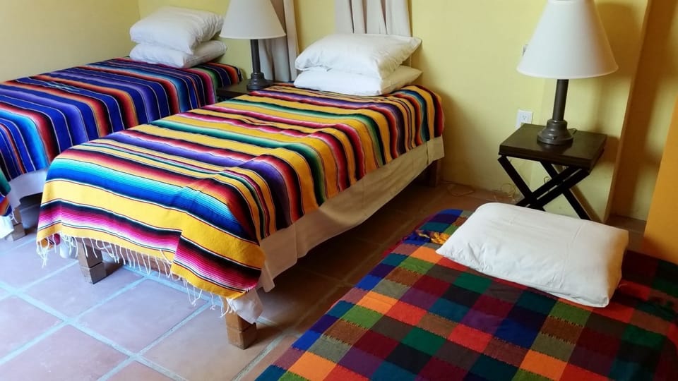 Second bedroom setup with three twin beds.