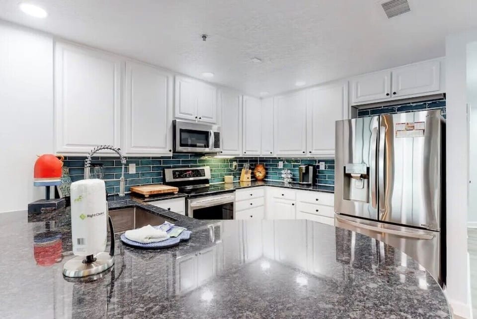 Large granite countertop with view of gulf while you prepare a meal