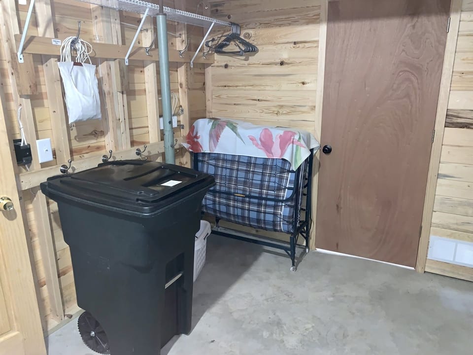 Another view of laundry/storage room w/ cot for extra sleeping option if needed.