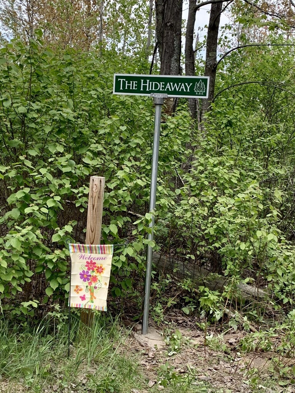 Welcome sign at entrance of The Hideaway driveway.