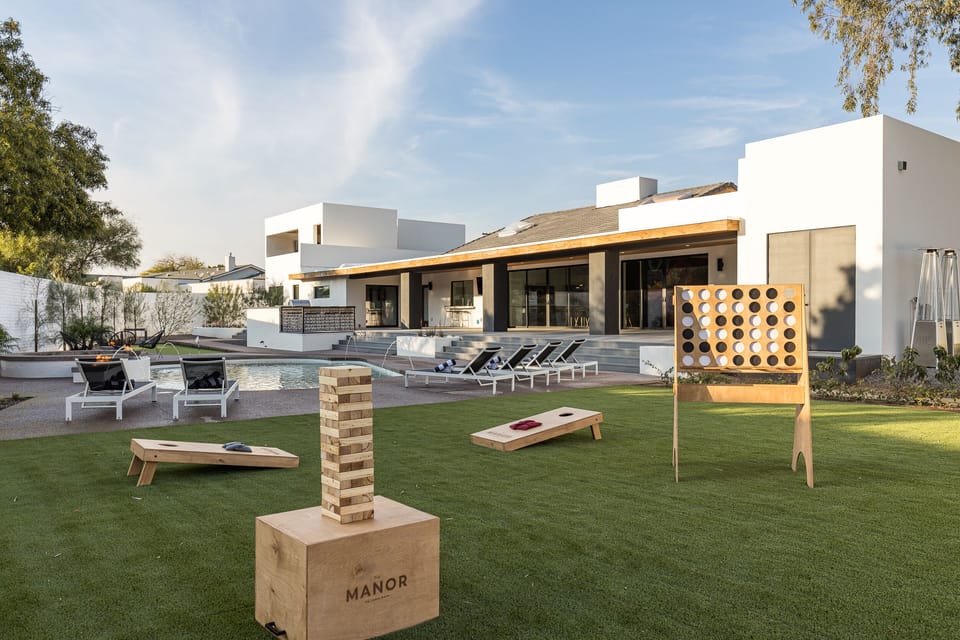 A lush turf area adjacent to a stunning pool and spa creates the perfect setting for yard games.