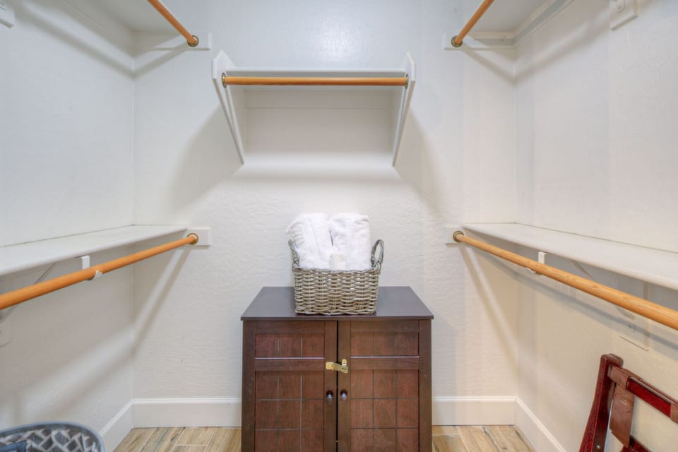 Walk-in closet in the primary suite is ready for you to unpack your wardrobe and accessories.