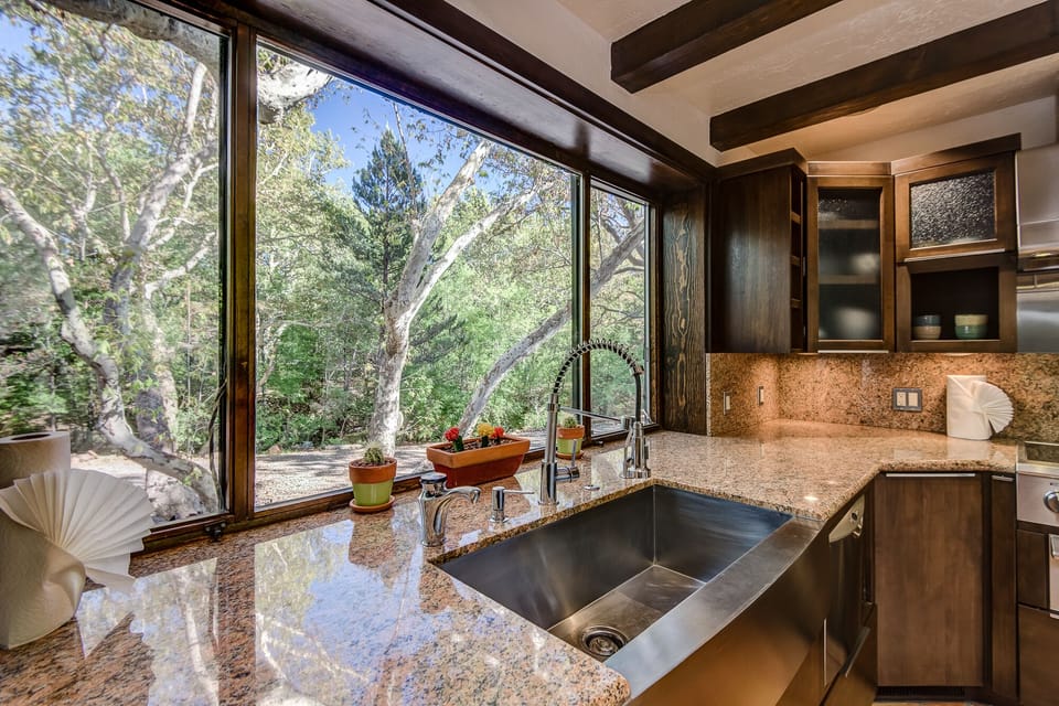 Granite Counters, Stainless Farm Sink, and an Expansive Window for Natural Light and Views