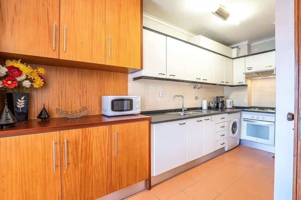 Kitchen full equipped, with ample storage.