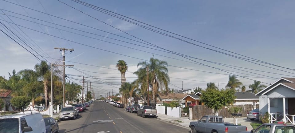 In front of the red house looking North into the neighborhood