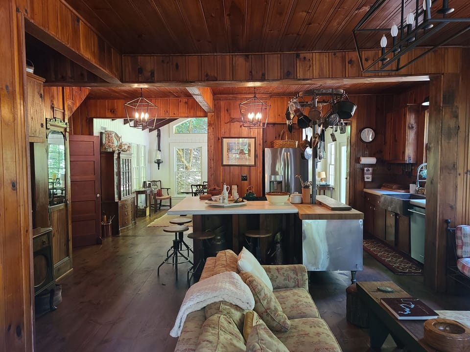 comfortable den with gas fireplace and connecting kitchen  and dining