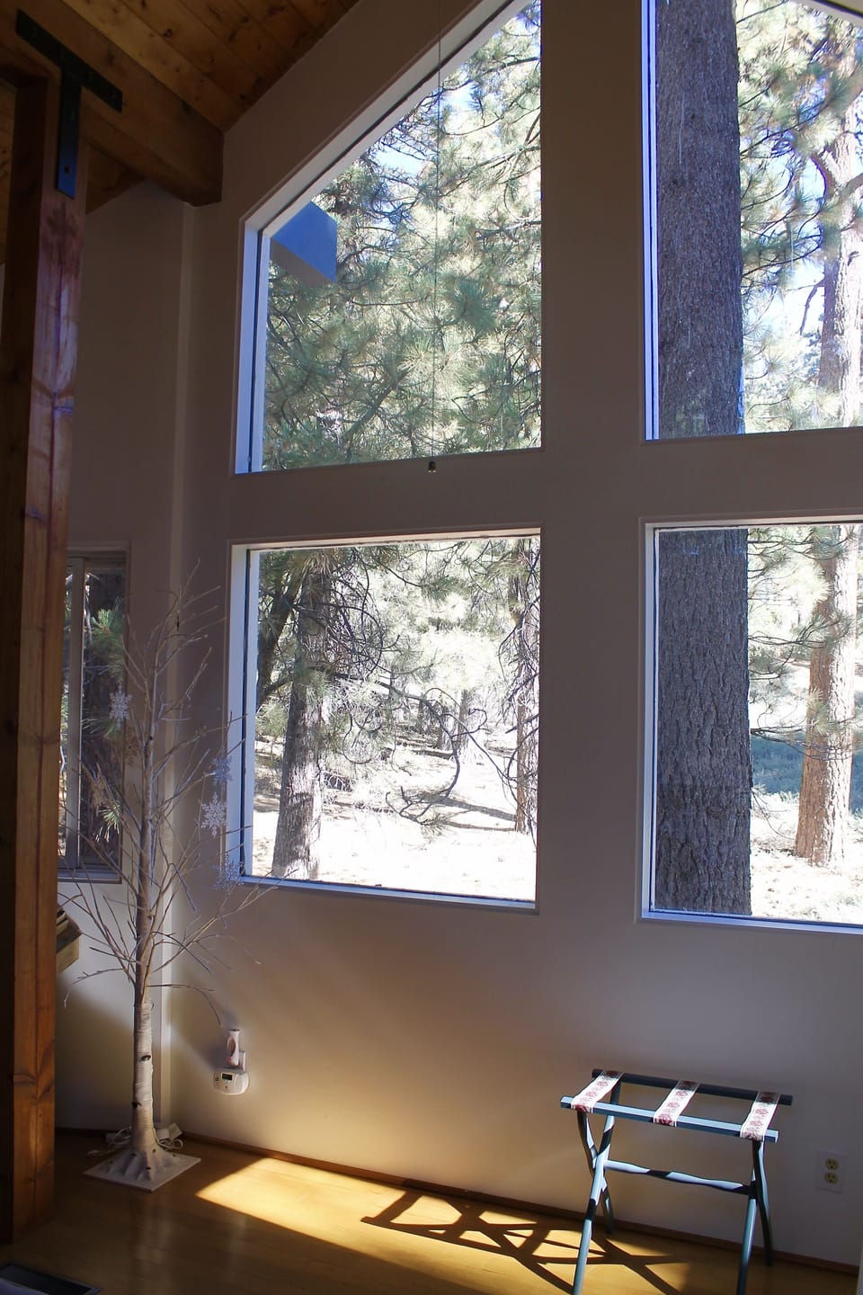 Wall of windows in the treetop master bedroom. Perfect for stargazing.