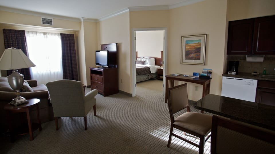 Inviting suite with comfortable seating and open bedroom view.
