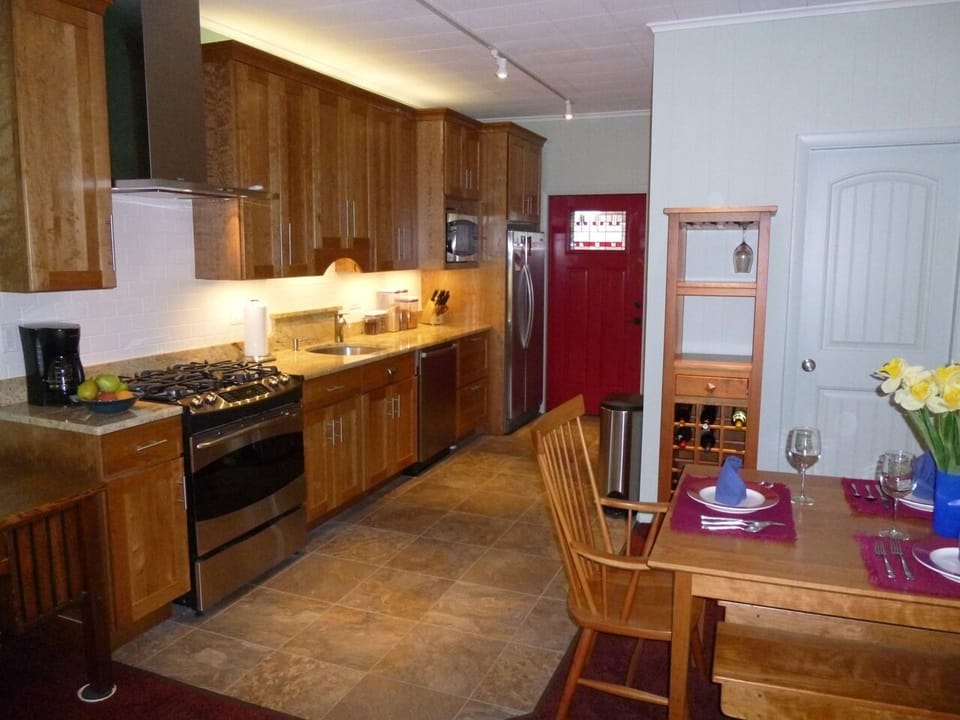 NEW COOKS' KITCHEN WITH GE PROFILE ULTRA-QUIET APPLIANCES, GRANITE COUNTERS AND WINE TOWER.