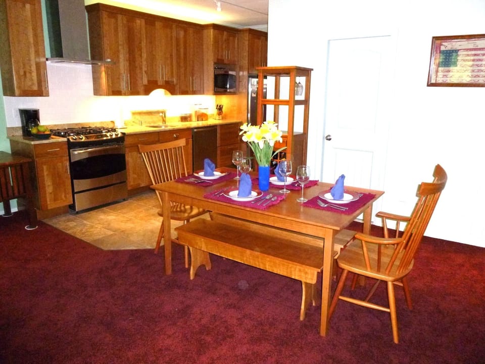 DINING/KITCHEN AREA WITH SOLID CHERRY FURNITURE AND CABINETRY, LUXURY APPLIANCES AND GRANITE COUNTERTOPS.