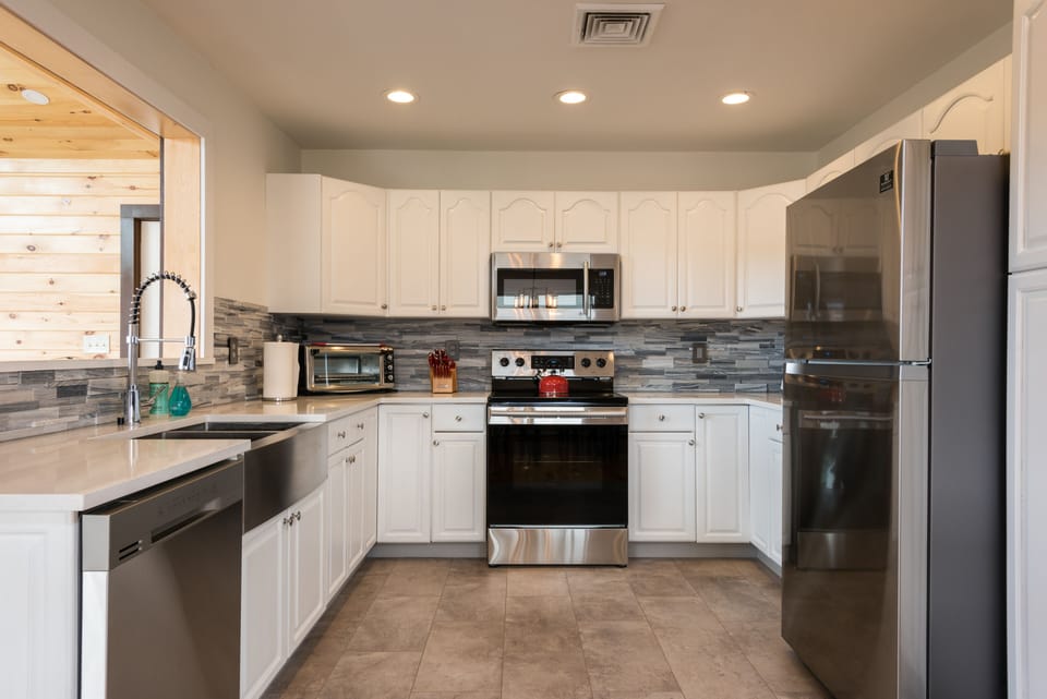 Fully stocked kitchen wit pots, pans, toaster, microwave, coffee maker, blender