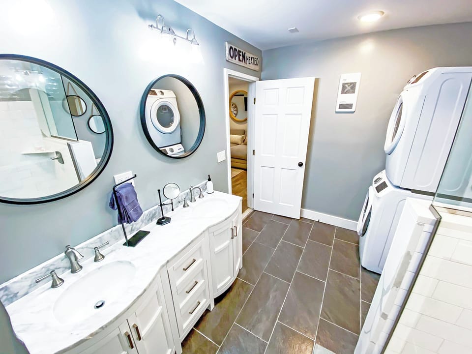 Lake-level bathroom with double sinks and shower