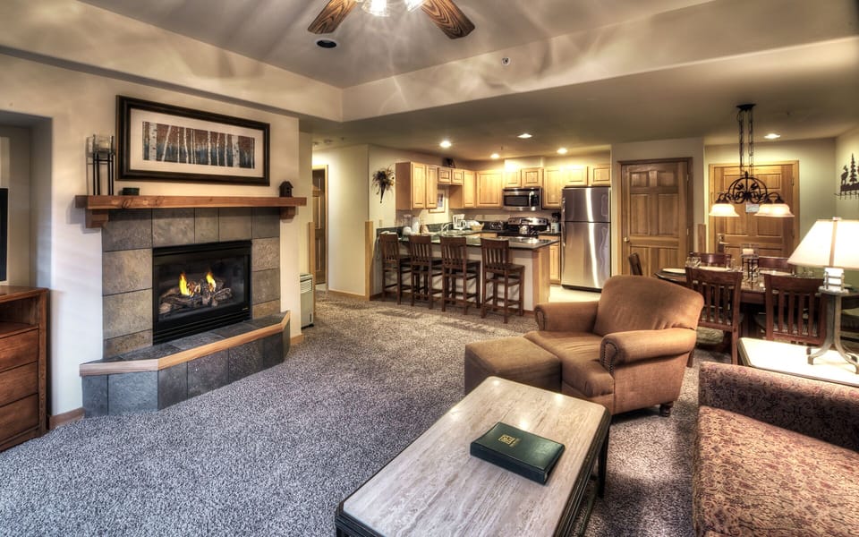 View of fireplace/family room and kitchen/dining area.