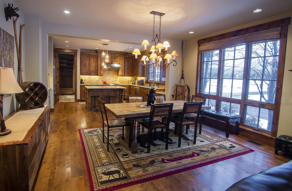 Gather around this inviting dining space where warm wood tones and rustic charm create the perfect atmosphere for your morning coffee or evening meals with loved ones.