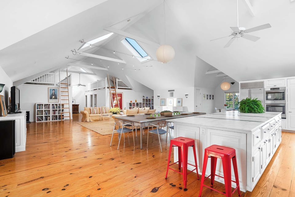 Expansive living space with kitchen, dining, and dual lofts